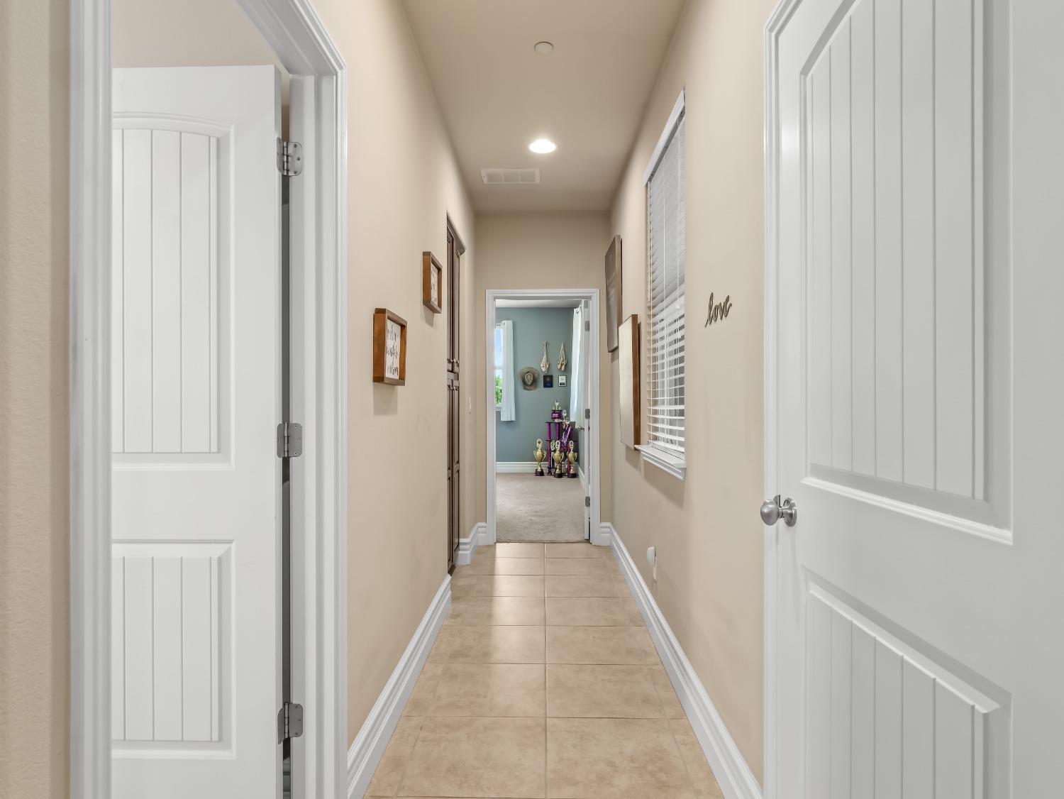 948 Whitmore Avenue Clovis, CA 93619 - Photo 12 of 38 a view of a hallway with wooden floor and closet area