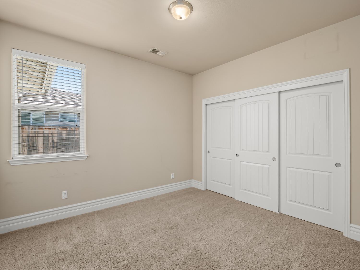 948 Whitmore Avenue Clovis, CA 93619 - Photo 14 of 38 an empty room with windows and closet