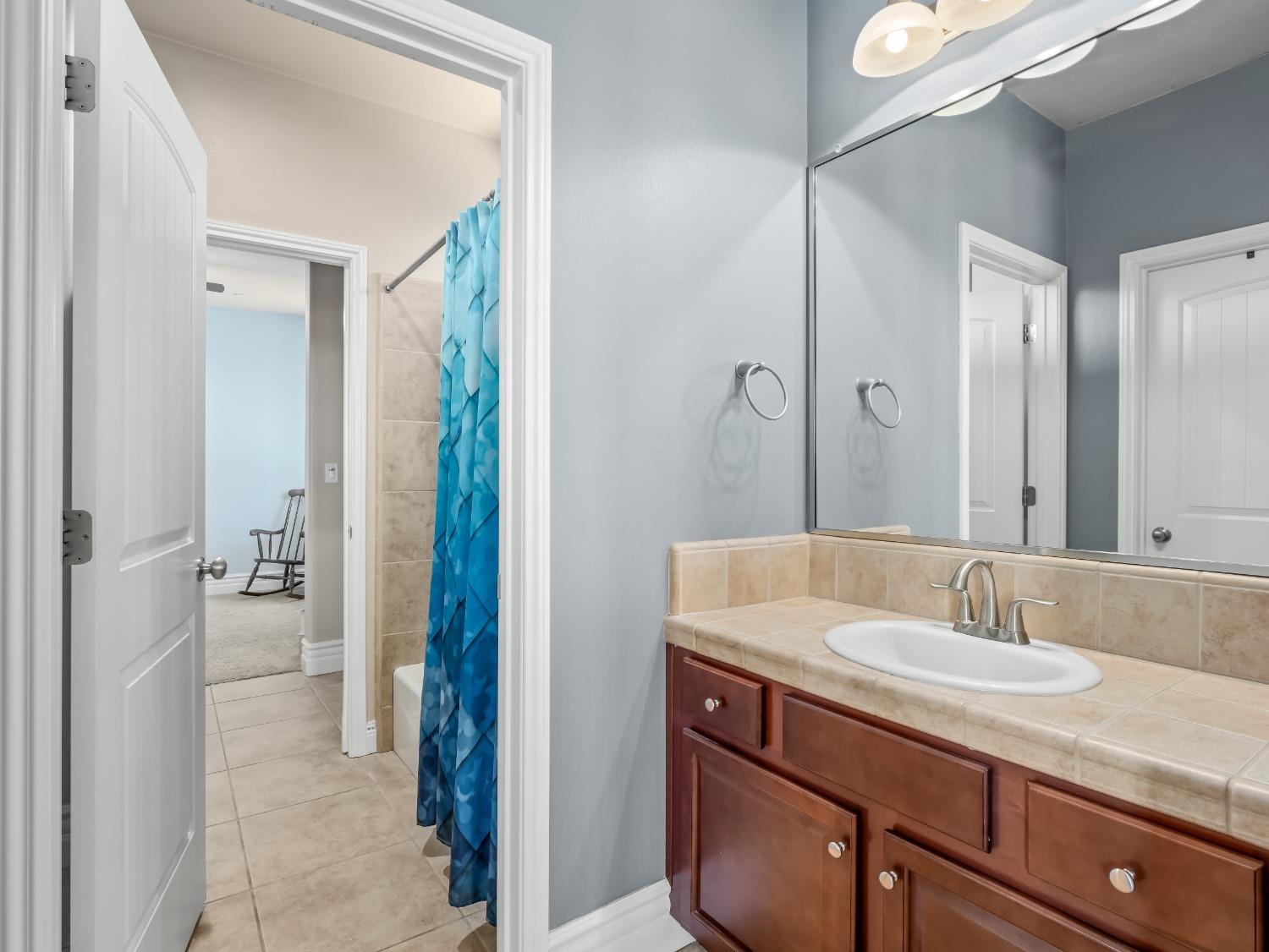 948 Whitmore Avenue Clovis, CA 93619 - Photo 19 of 38 a bathroom with a sink and a mirror