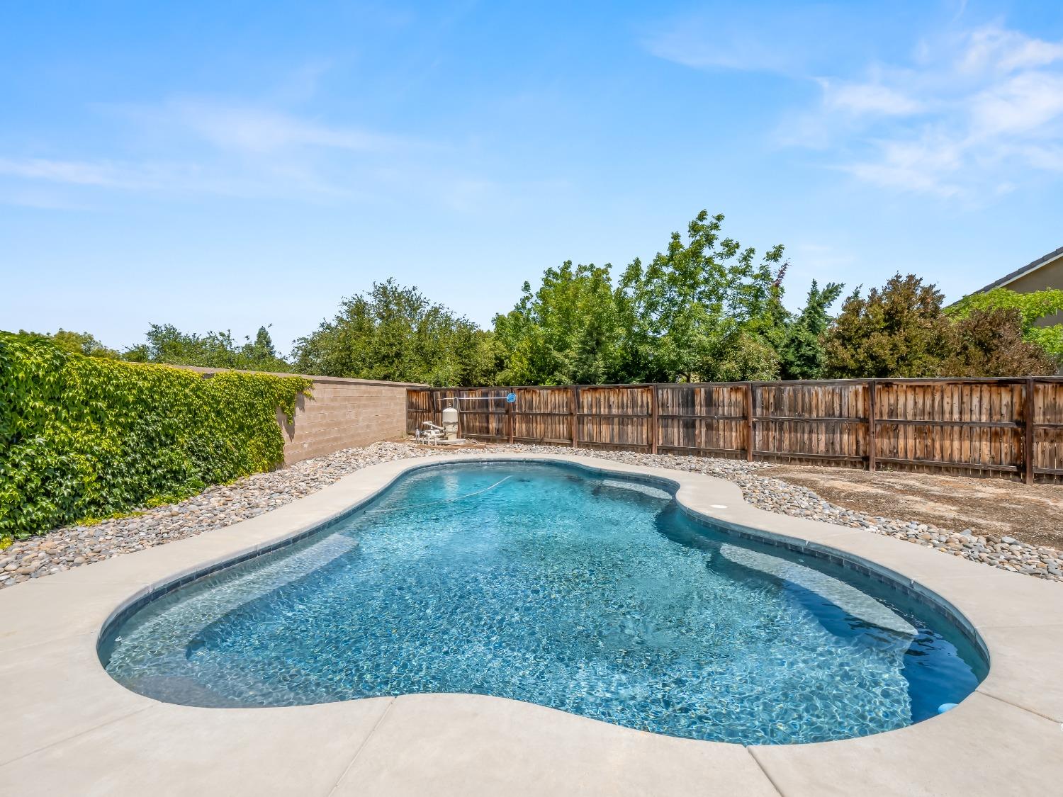 948 Whitmore Avenue Clovis, CA 93619 - Photo 28 of 38 a view of a backyard with swimming pool