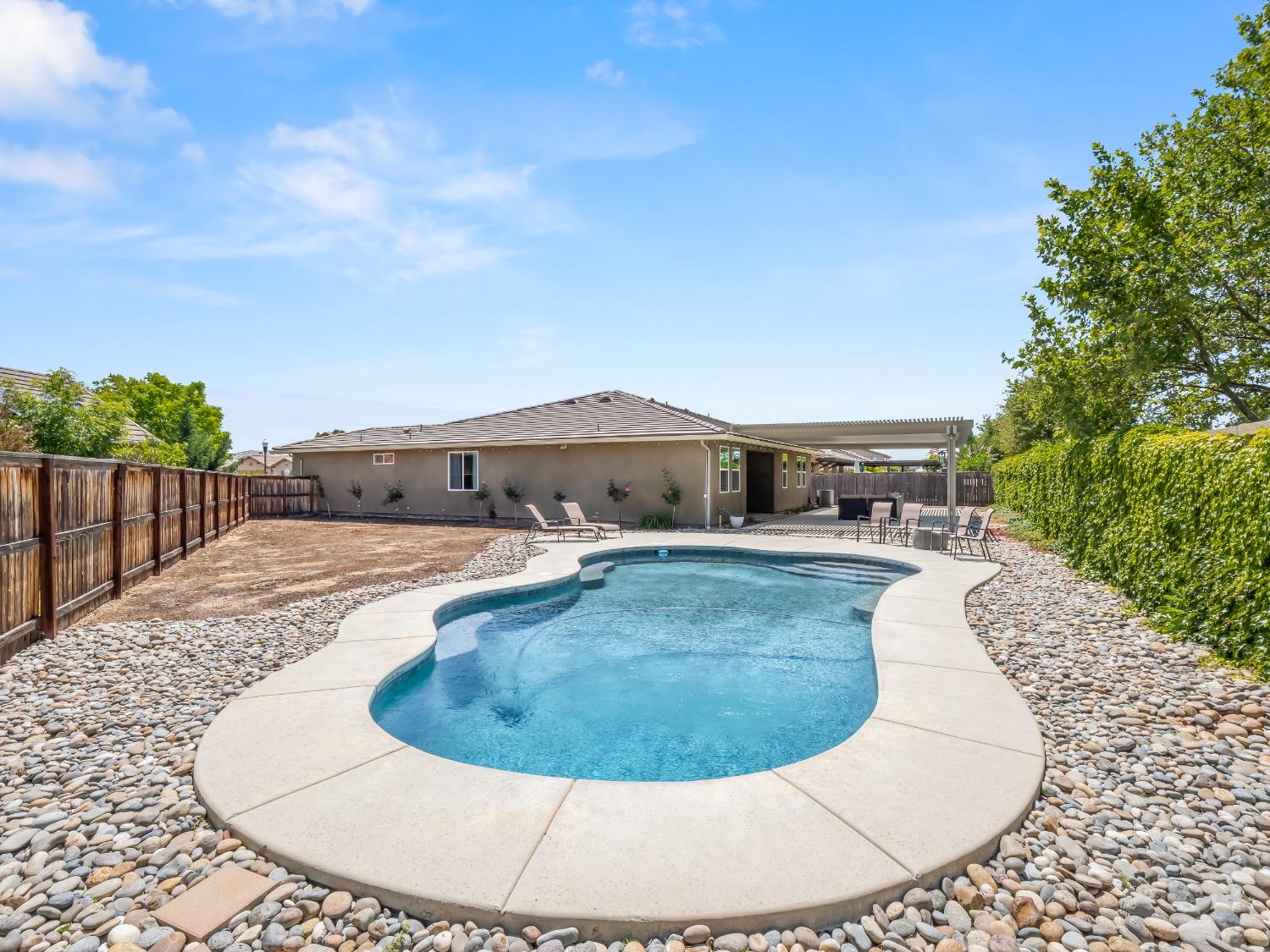 948 Whitmore Avenue Clovis, CA 93619 - Photo 29 of 38 a view of a swimming pool with a patio