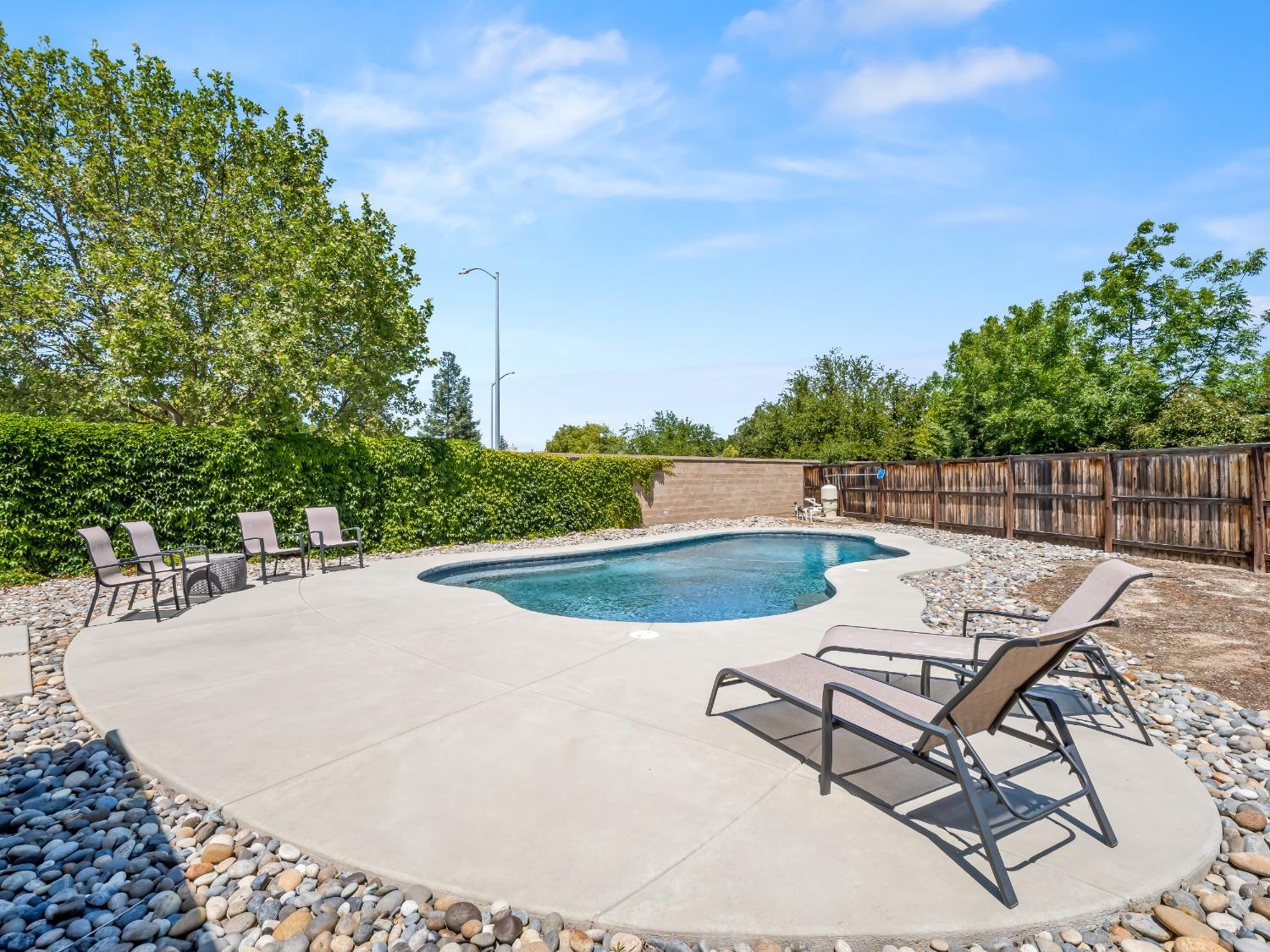 948 Whitmore Avenue Clovis, CA 93619 - Photo 30 of 38 a view of a swimming pool with a patio