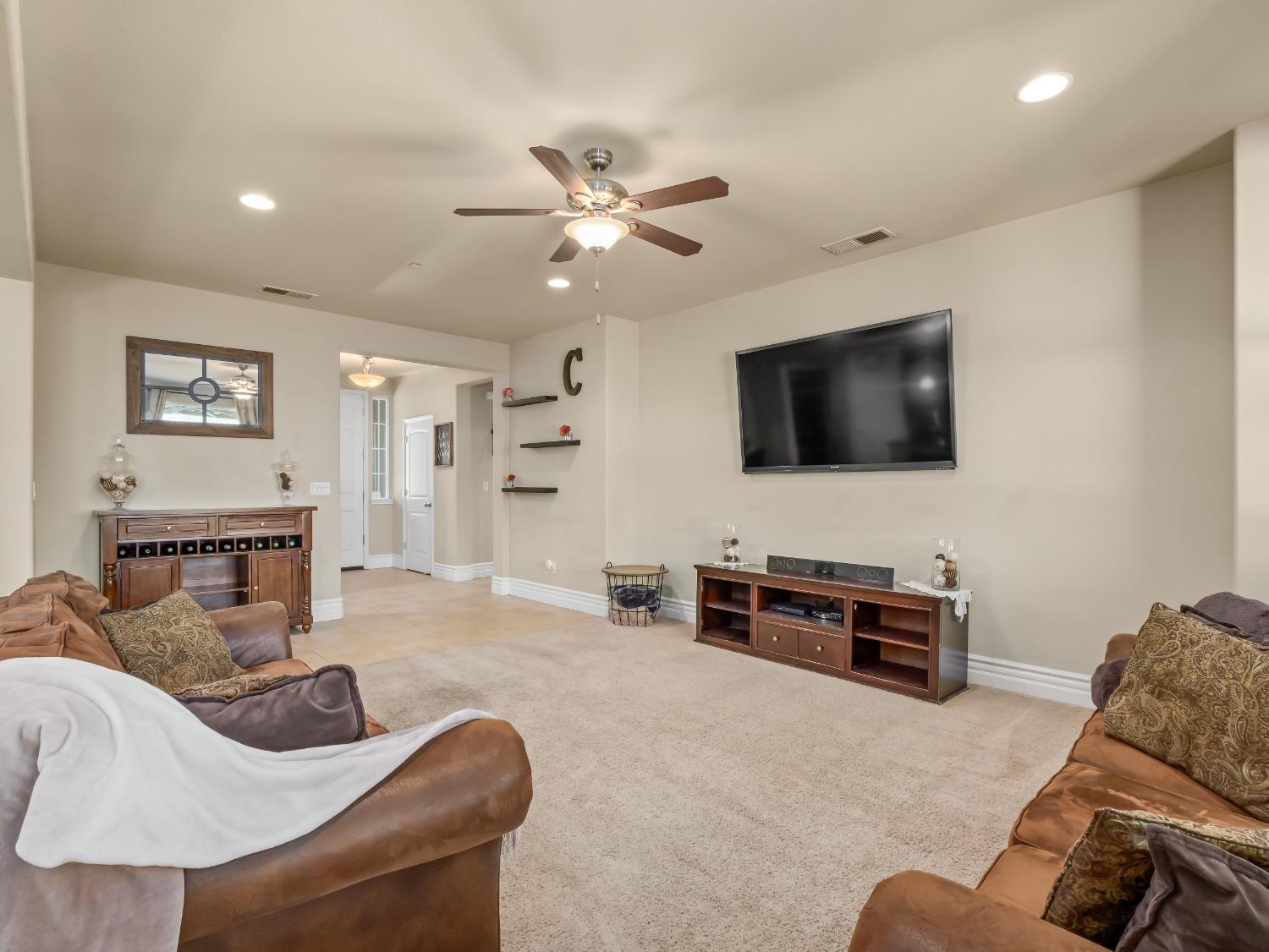 948 Whitmore Avenue Clovis, CA 93619 - Photo 5 of 38 a living room with furniture and a flat screen tv
