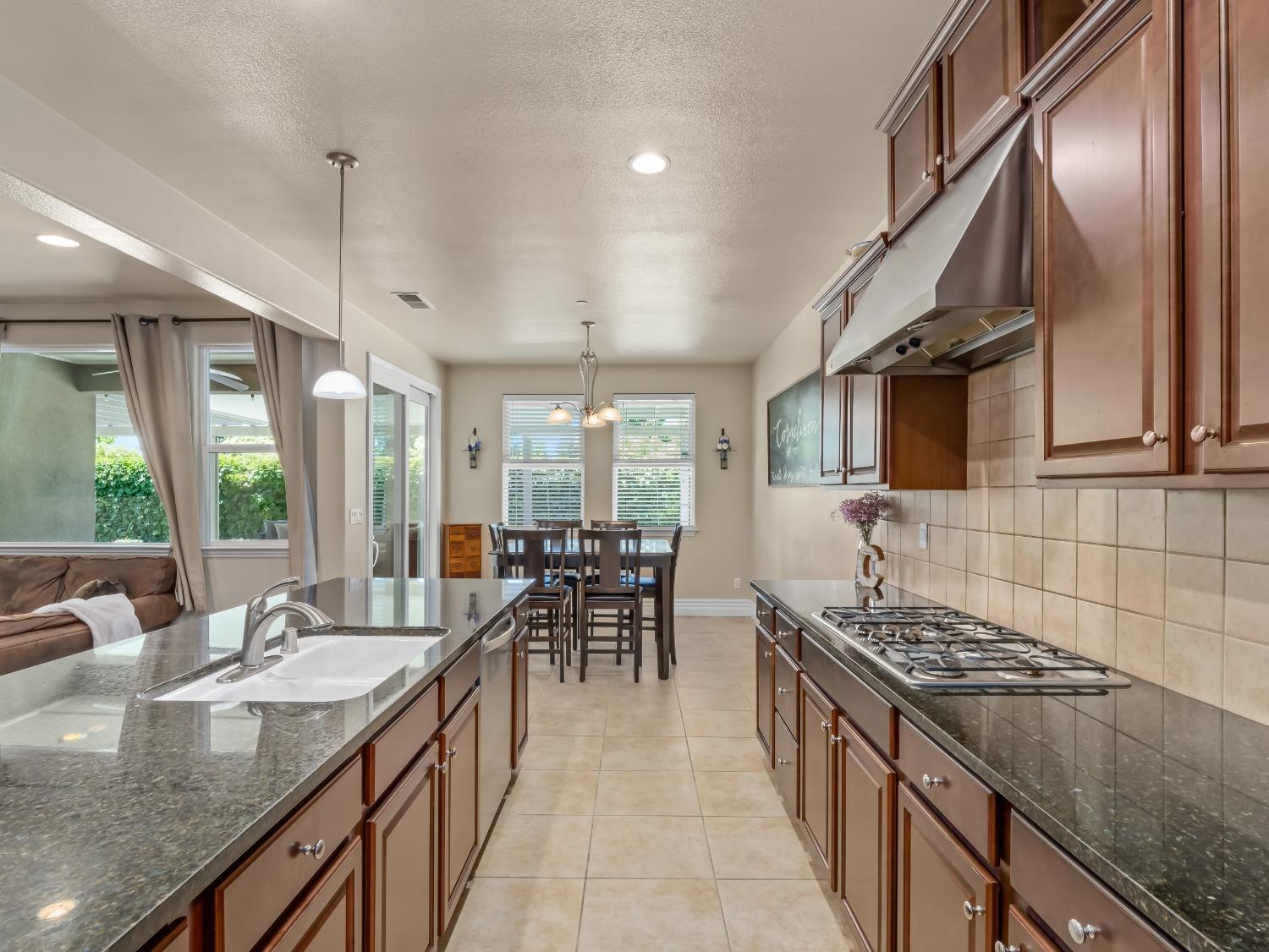 948 Whitmore Avenue Clovis, CA 93619 - Photo 9 of 38 a kitchen with sink stove top oven and cabinets