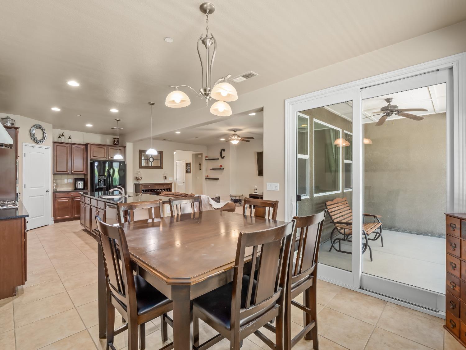 948 Whitmore Avenue Clovis, CA 93619 - Photo 10 of 38 a view of a dining room and livingroom with furniture wooden floor a chandelier