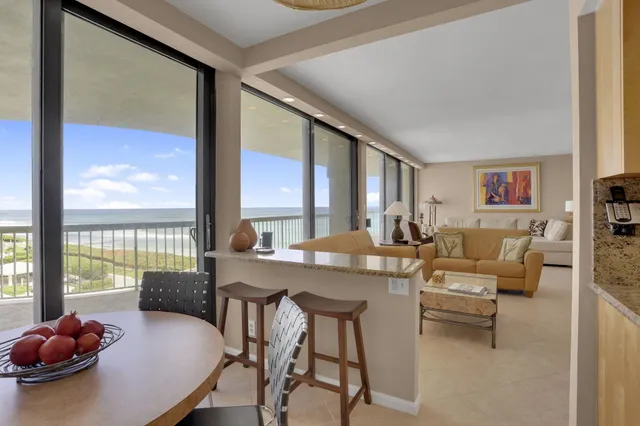 a view of a dining room with furniture and a large window