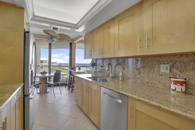 a kitchen with a sink a counter top space and cabinets