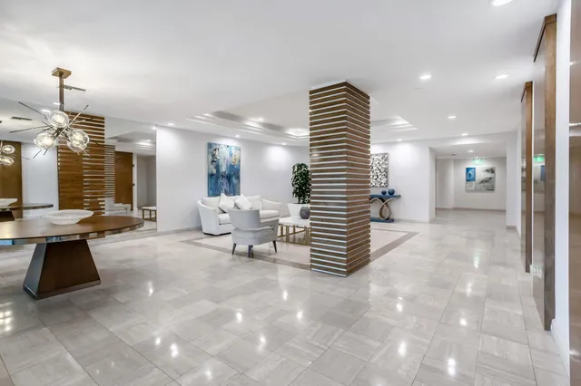 a lobby with furniture and stairs