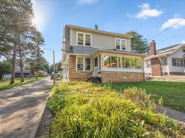a front view of a house with a yard table and chairs