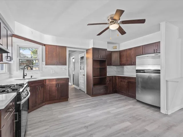 a kitchen with stainless steel appliances a stove a refrigerator and a sink
