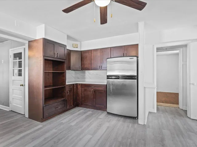 a kitchen with stainless steel appliances a refrigerator and a stove top oven