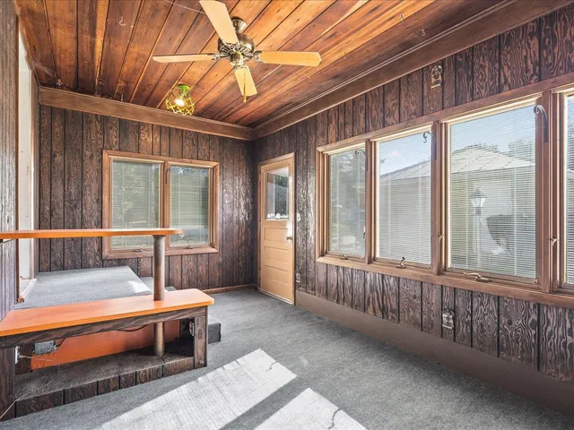 a bedroom with furniture and large window