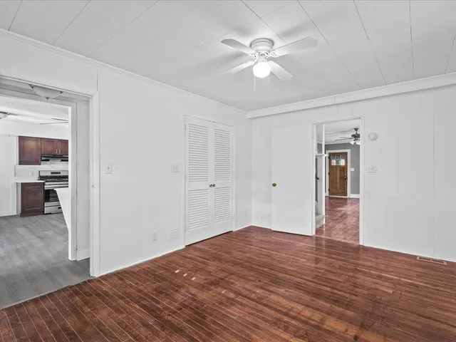 a view of empty room with wooden floor
