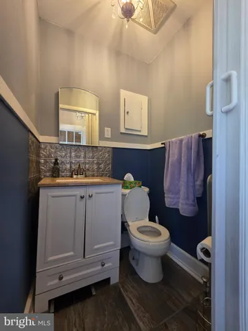 a bathroom with a toilet sink and mirror