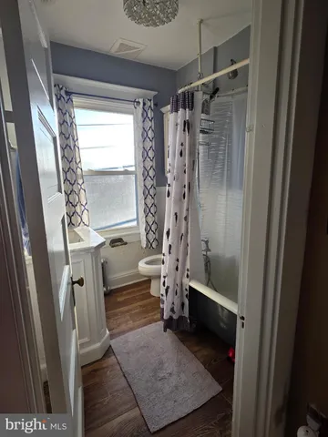 a bathroom with a shower a sink and a toilet