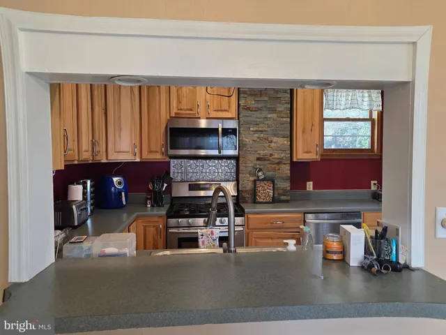 a living room with furniture a fireplace and large window