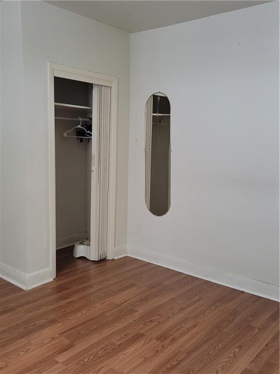 5557 Beacon Street Pittsburgh, PA 15217 - Photo 9 of 14 an empty room with wooden floor and closet