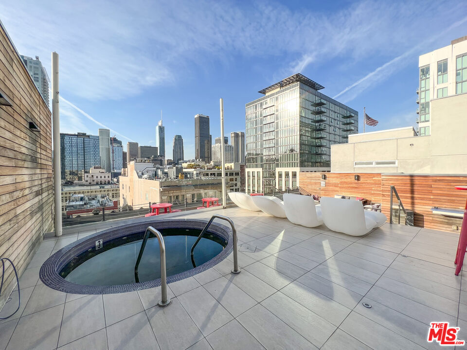810 South Spring Street, Unit 802 Los Angeles, CA 90014 - Photo 14 of 18 a living room with furniture and a large window