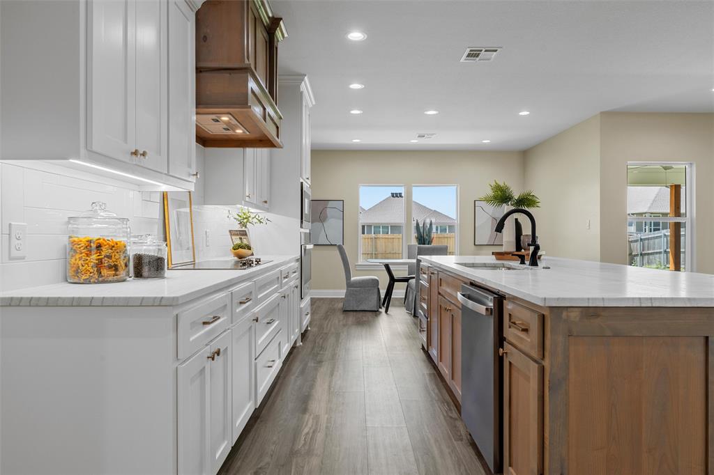 929 Northern Dancer Drive Hewitt, TX 76643 - Photo 6 of 36 a kitchen with counter top space a sink and wooden floor