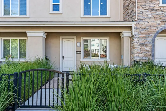 a view of a house with a small yard and plants