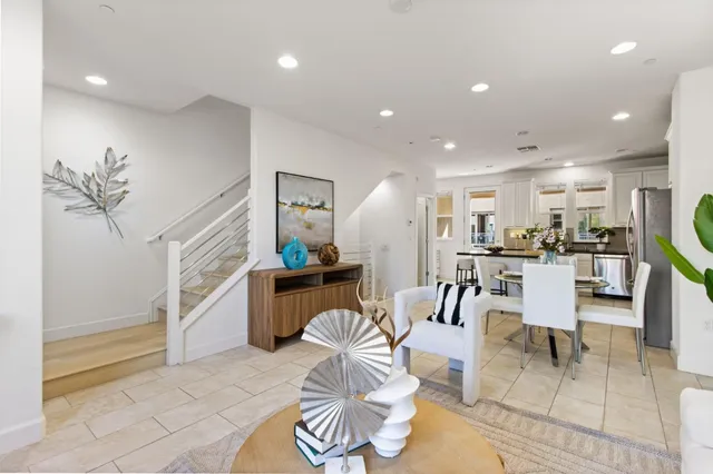 a living room with furniture and a kitchen view