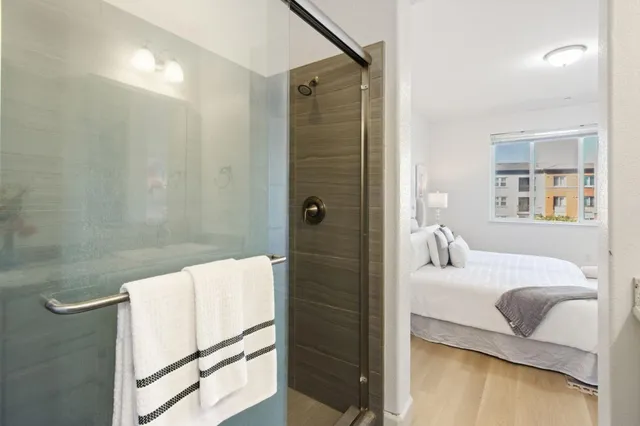 a bedroom with a bed and a shower