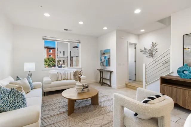 a living room with furniture and a potted plant