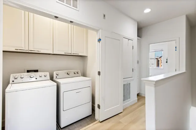 a view of storage and utility room with washer and dryer