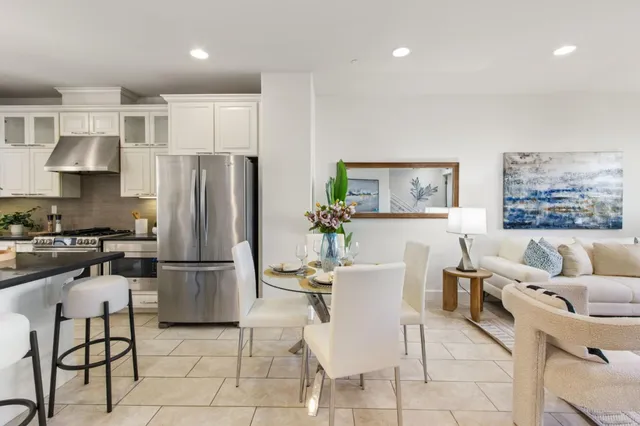 a kitchen with stainless steel appliances kitchen island granite countertop a refrigerator and a stove top oven