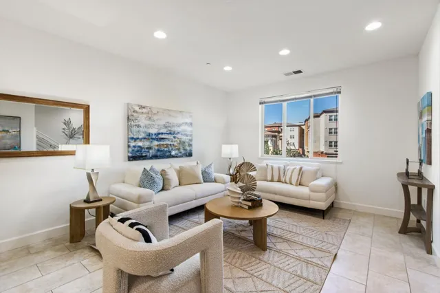 a living room with furniture a rug and a window