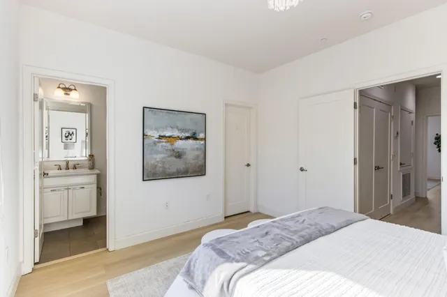 a bedroom with a bed and a chandelier