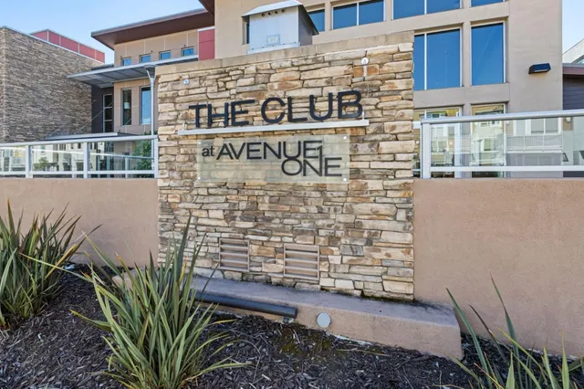 a view of a patio with a table and chairs under an umbrella