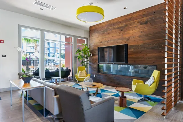 a room with gym equipment and large windows