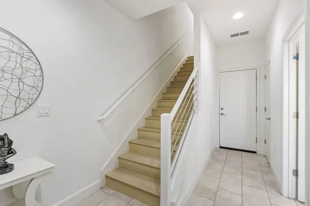 a view of a hallway with wooden floor and entryway