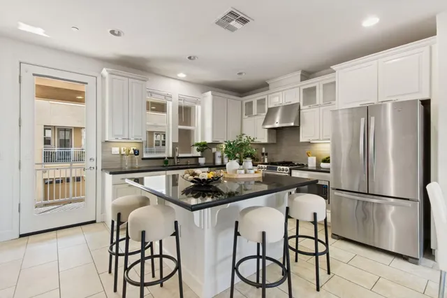 a kitchen with refrigerator a stove and cabinets