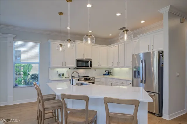 a kitchen with kitchen island appliances cabinets and furniture
