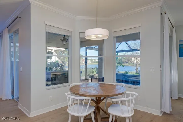 a view of a dining room with furniture wooden floor and chandelier