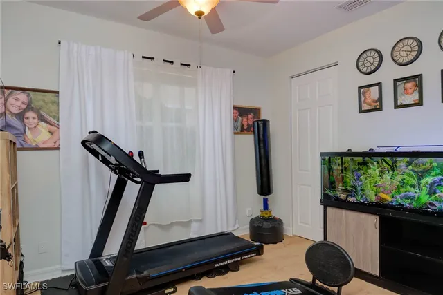 a room with gym equipment and a chandelier