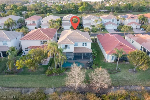 an aerial view of residential houses with outdoor space and street view