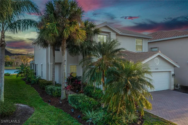 a yellow and red house with a palm tree in front of it