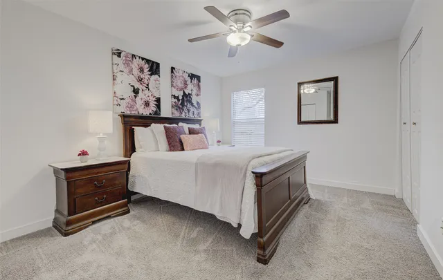 a spacious bedroom with a bed and a chandelier