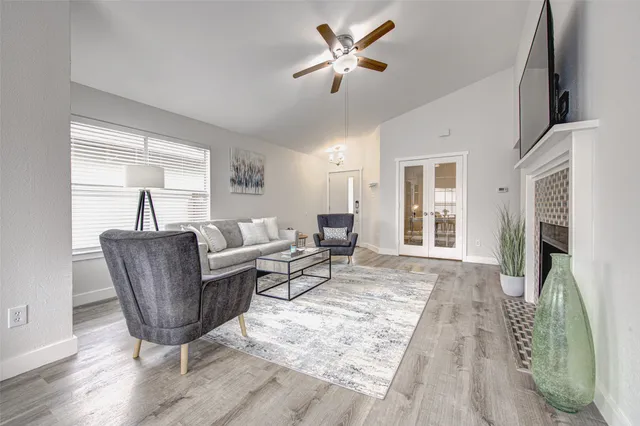 a living room with furniture and a wooden floor