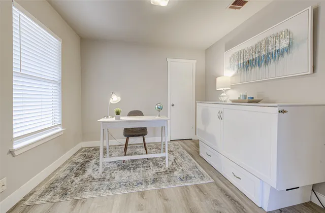 a room that has a rug and a table in it