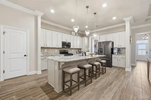 a large kitchen with lots of counter space and stainless steel appliances