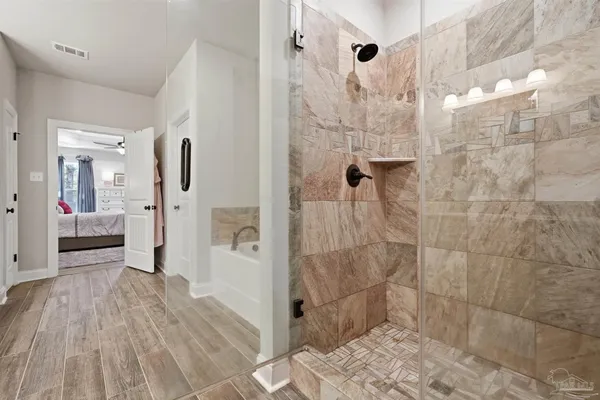 a bathroom with a granite countertop sink a toilet and a shower