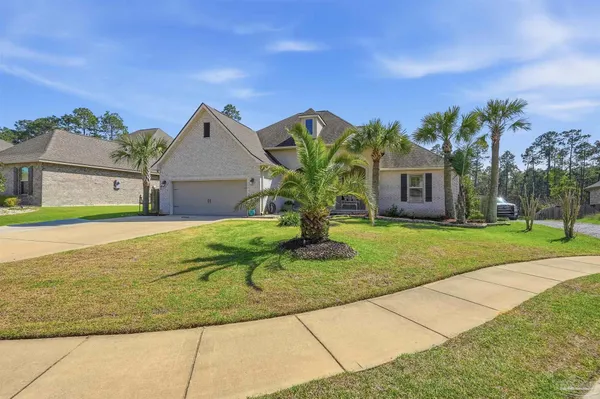 a front view of a house with a garden and plants