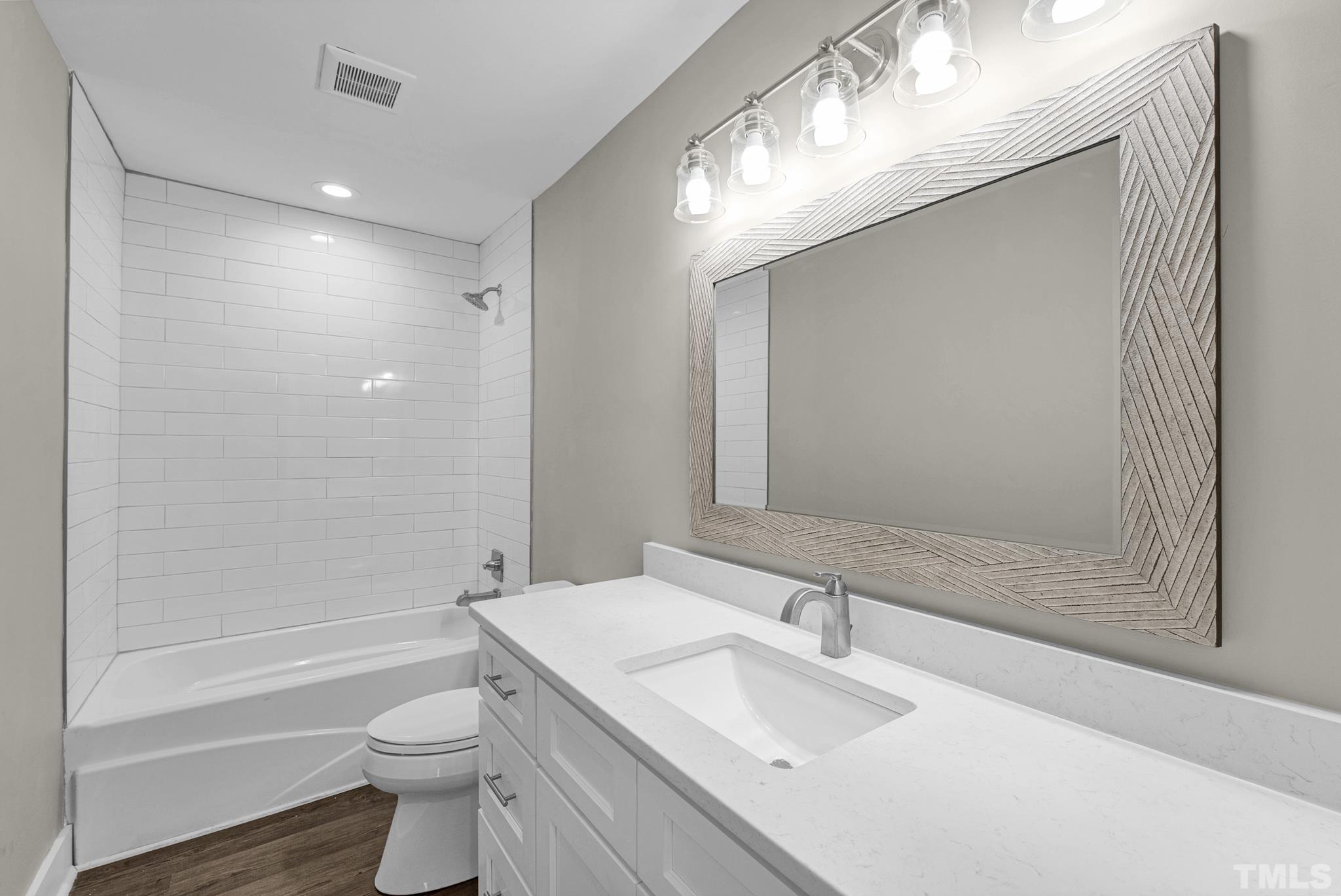 6712 Millbridge Court Raleigh, NC 27615 - Photo 14 of 25 a bathroom with a sink toilet and shower