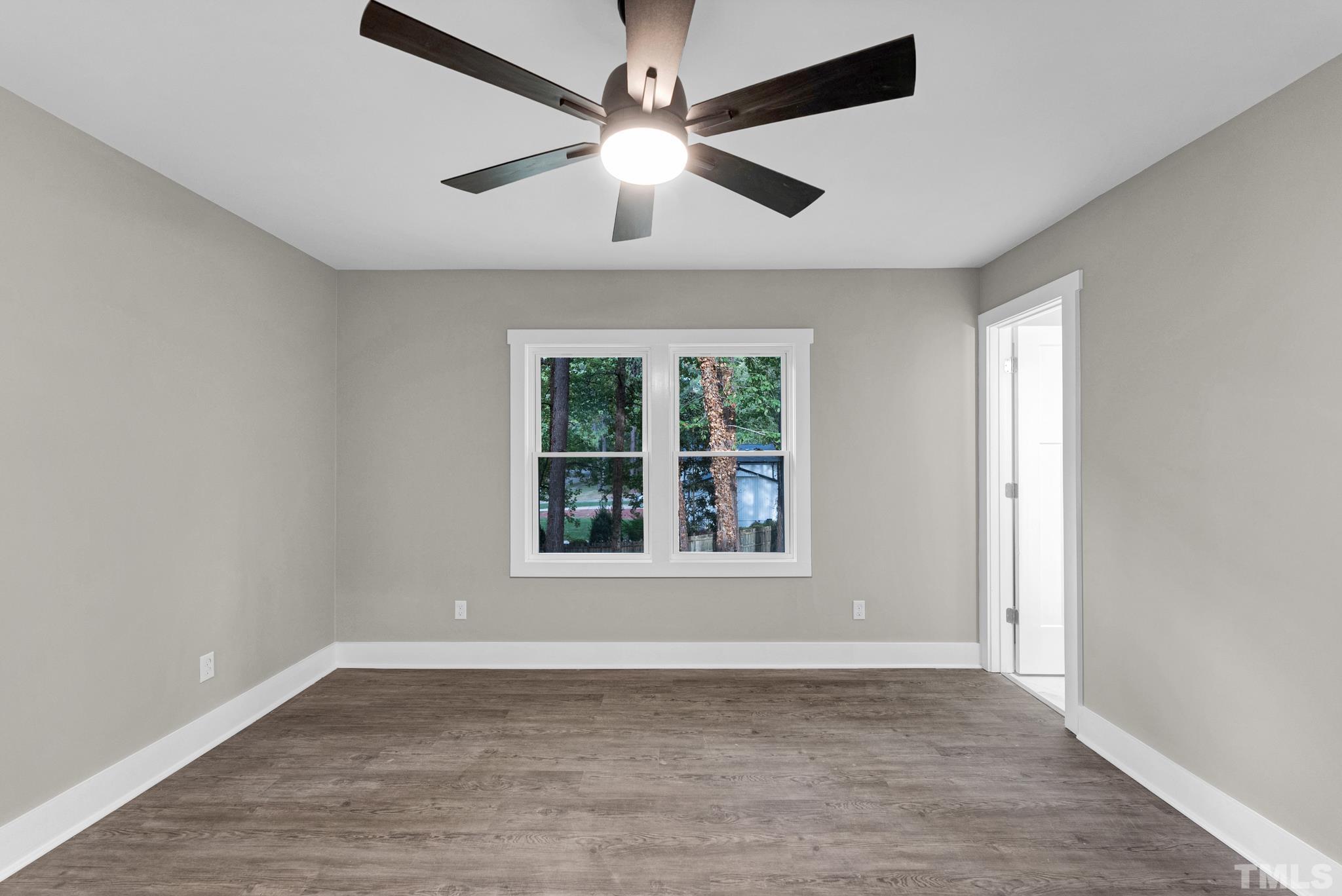 6712 Millbridge Court Raleigh, NC 27615 - Photo 17 of 25 an empty room with wooden floor and windows