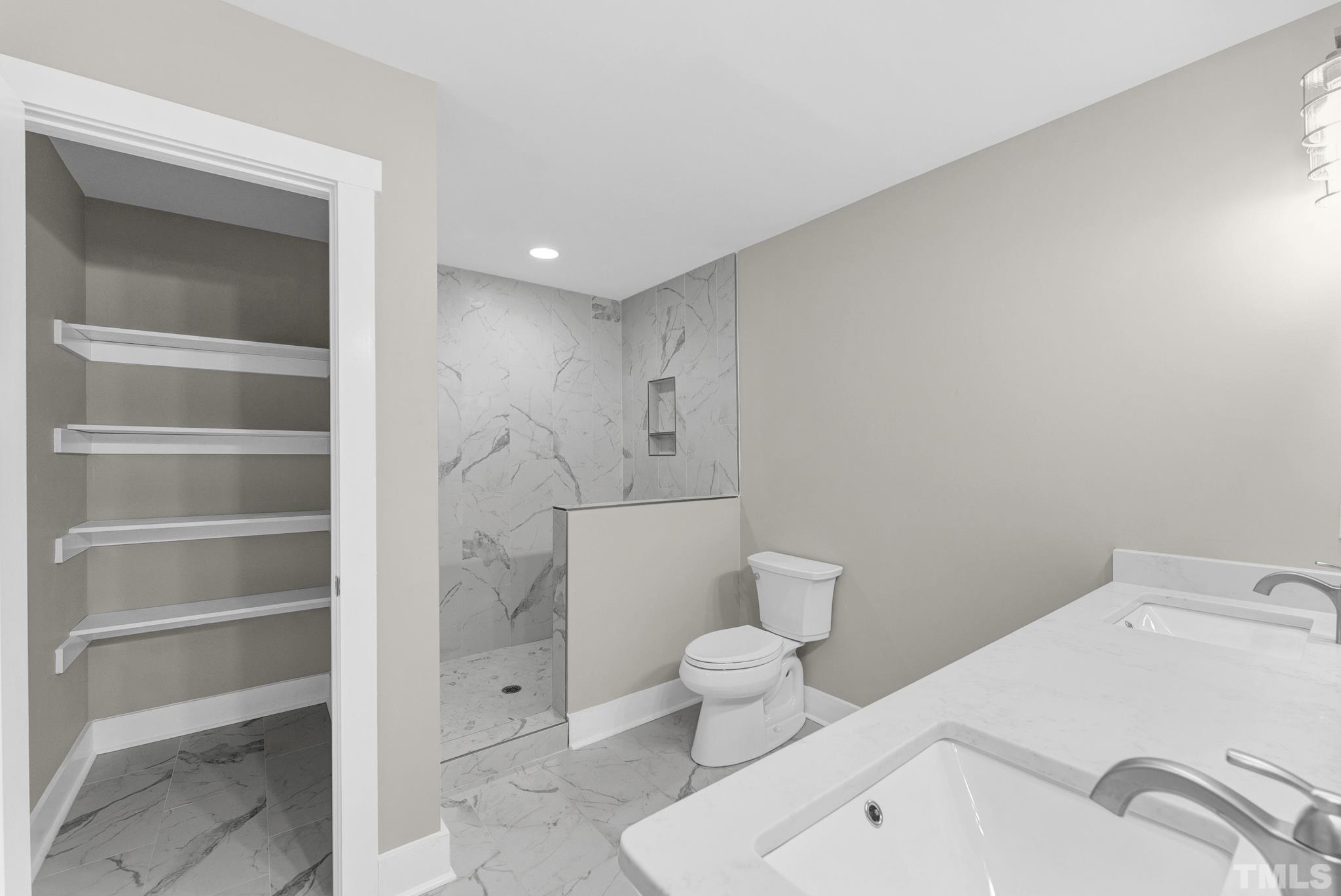 6712 Millbridge Court Raleigh, NC 27615 - Photo 19 of 25 a bathroom with a toilet sink and shower