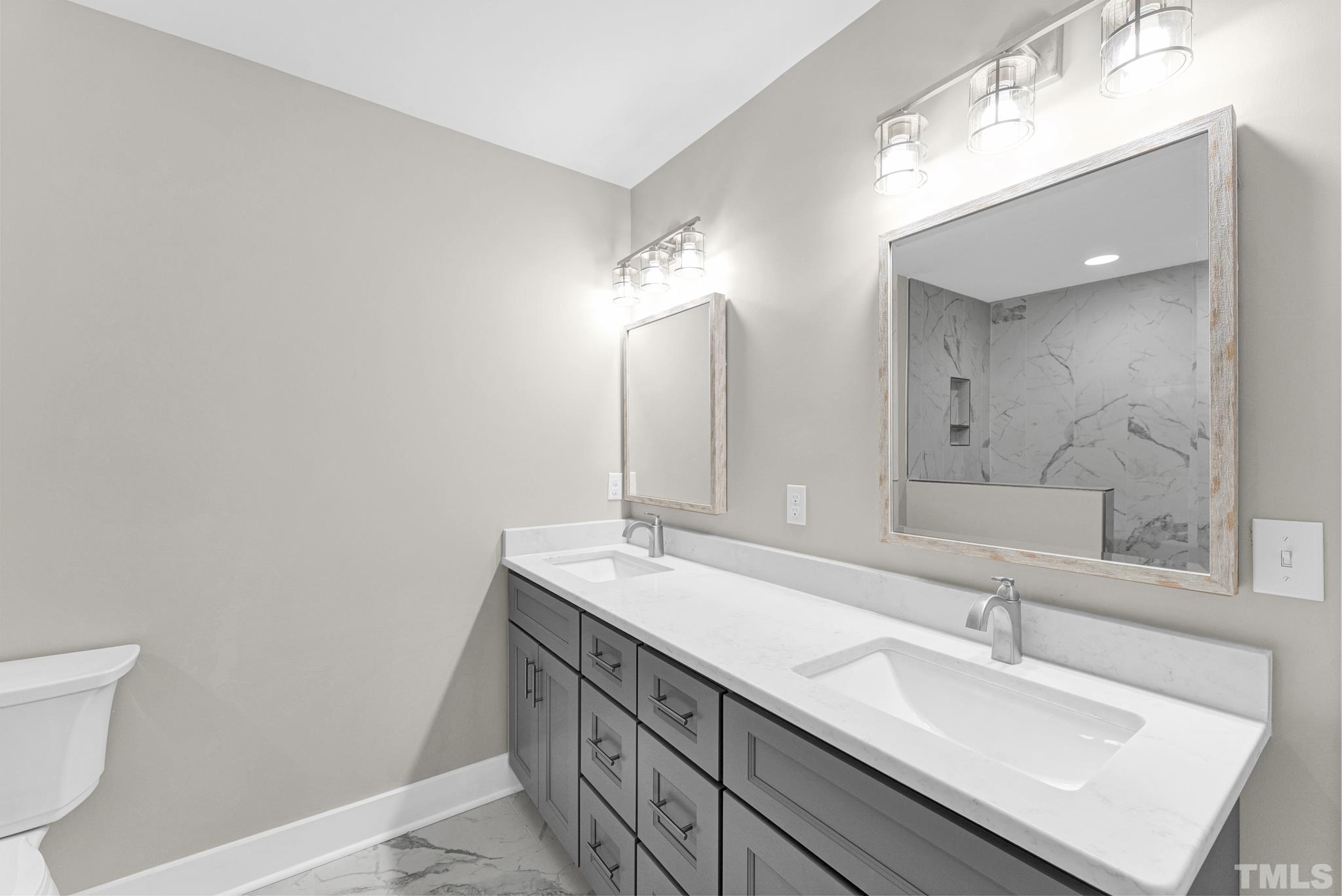 6712 Millbridge Court Raleigh, NC 27615 - Photo 20 of 25 a bathroom with a sink and a mirror